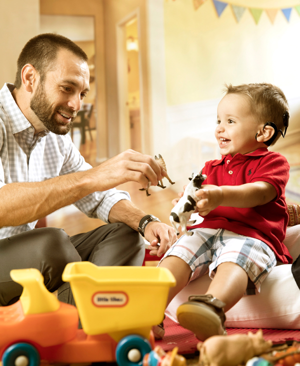 A man and toddler playing with toys