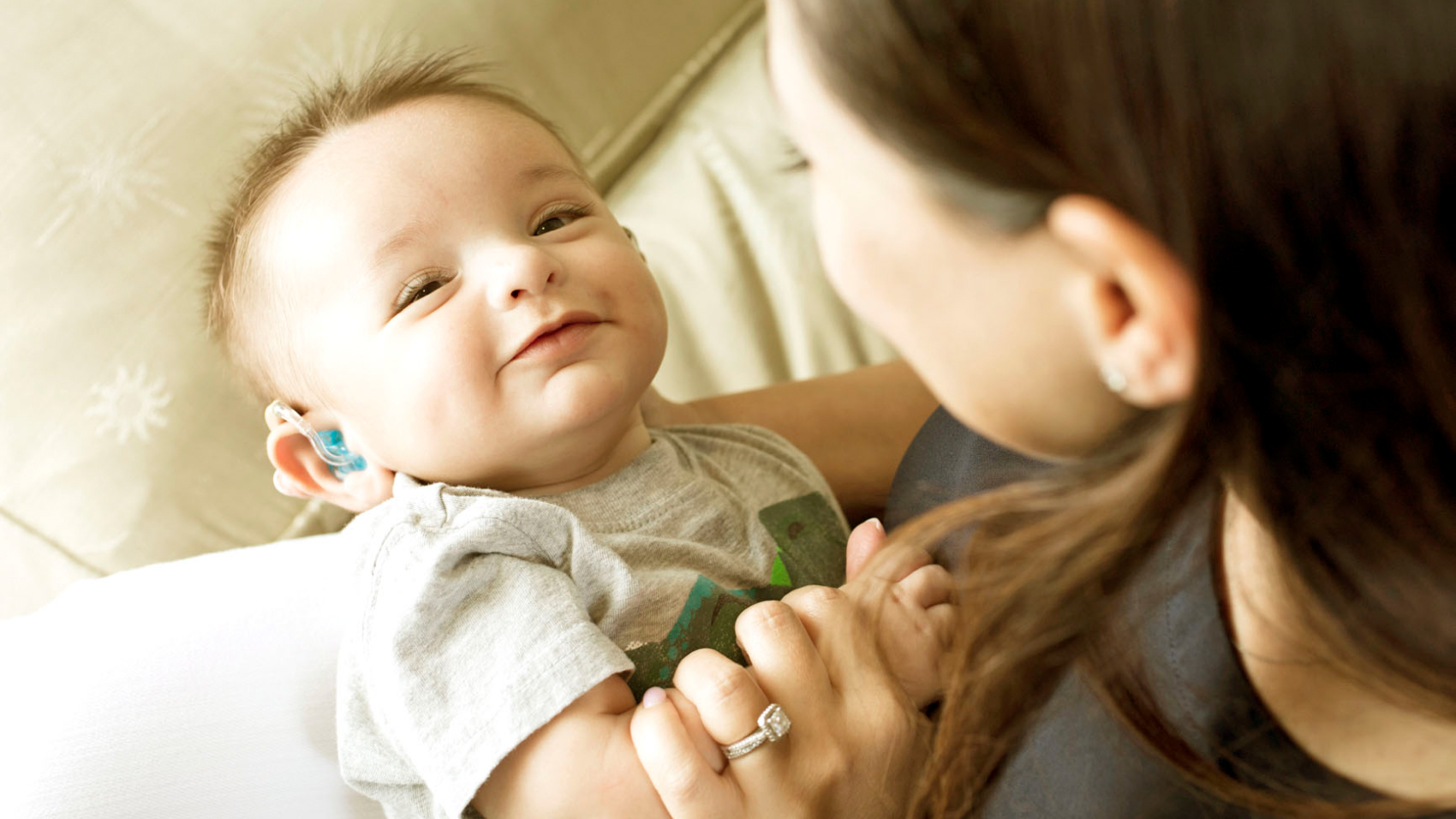 A woman holding a smiling baby